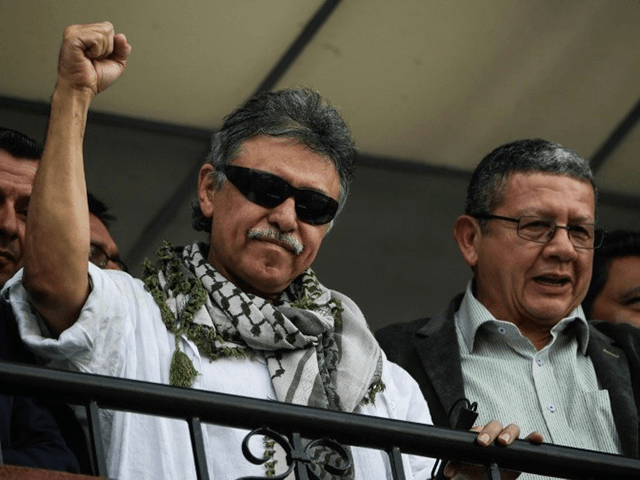 Former FARC commander Jesus Santrich (L) greets supporters after the Supreme Court ordered