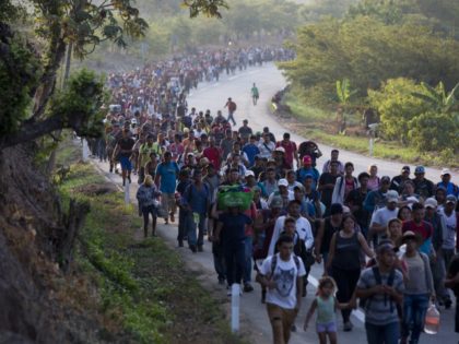 Central American migrants, part of a caravan hoping to reach the U.S. border, move on the road in Escuintla, Chiapas State, Mexico, Saturday, April 20, 2019. Thousands of migrants in several different caravans have been gathering in Chiapas in recent days and weeks. (AP Photo/Moises Castillo)