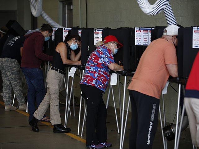 Voters wearing masks fill out their ballots inside a polling place at Indian Creek Fire Station #4 in Miami Beach, Fla., on Election Day, Tuesday, Nov. 3, 2020. (AP Photo/Rebecca Blackwell)
