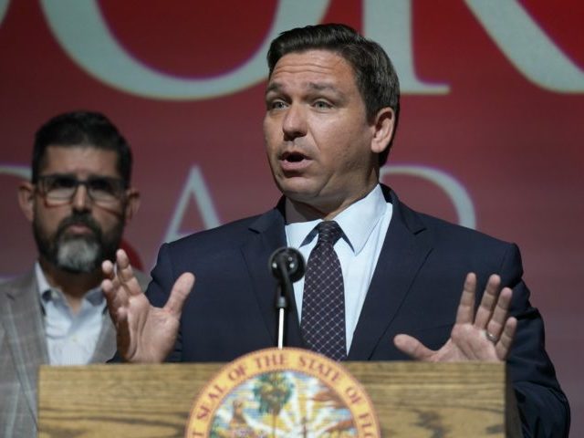 FILE - In this Tuesday, Sept. 14, 2021, file photo, Florida Gov. Ron DeSantis speaks at the Doral Academy Preparatory School in Doral, Fla. Florida filed suit against President Joe Biden's administration Tuesday, Sept. 28, 2021, claiming his immigration policy is illegal, and DeSantis signed an order barring state agencies …