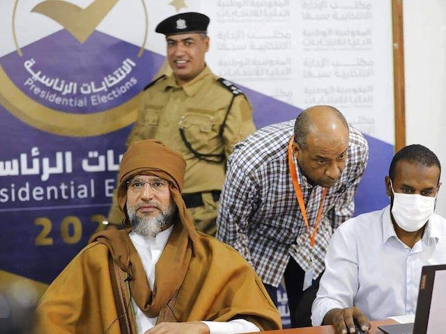 Seif al-Islam, left, the son and one-time heir apparent of late Libyan dictator Moammar Gadhafi registers his candidacy for the country’s presidential elections next month, in Sabha, Libya, Sunday, Nov. 14, 2021. Al-Islam, who was seen as the reformist face of Gadhafi's regime before the 2011 uprising, was released in …