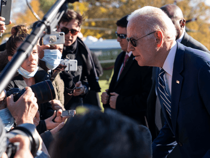 President Joe Biden leans to hear a reporter's question as he returns to the White House,