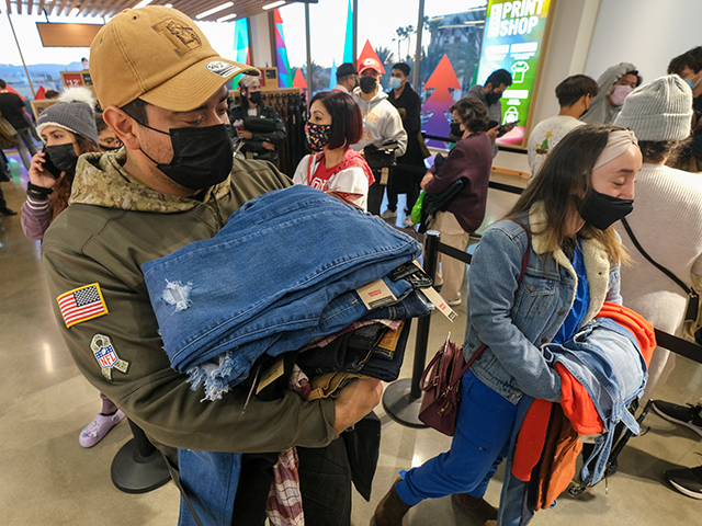 Black Friday shoppers wearing face masks shop at a store at the Citadel Outlets in Commerce, Calif., Friday, Nov. 26, 2021. (AP Photo/Ringo H.W. Chiu)
