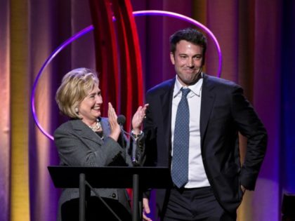 Former Secretary of State Hillary Rodham Clinton applauds actor Ben Affleck, right, during the Clinton Global Initiative's annual awards on Wednesday, Sept. 25, 2013, in New York. Clinton and Joe Biden appeared together during the event. (AP Photo/Craig Ruttle)