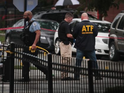 CHICAGO, ILLINOIS - JULY 21: An ATF agent and Police investigate the scene of a shooting i