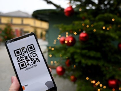 An illustration photo taken on November 12, 2021 shows a person showing the QR code for the online registration for the Hellbrunn Advent Magic Christmas Market on a smartphone, as the market will only give access according to the 2G rule (vaccinated or recovered), in Salzburg, Austria, ahead of the …