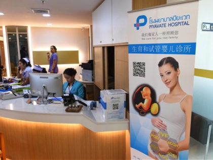 This photo taken on May 17, 2018 shows a poster in Chinese promoting in vitro fertilisation displayed in the lobby of Piyavate Hospital in Bangkok specialising in fertility treatment. - The easing of China's one-child policy was a godsend to Zhang Yinzhe and his wife Xu Mengsha, who had decided …