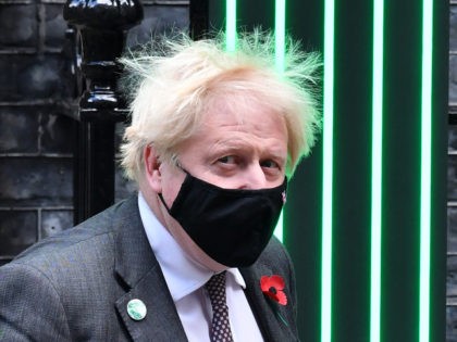 Britain's Prime Minister Boris Johnson, wearing a protective face covering to combat the spread of the coronavirus, leaves 10 Downing Street in central London on November 3, 2021, to take part in the weekly session of Prime Minister Questions (PMQs) at the House of Commons. (Photo by JUSTIN TALLIS / …