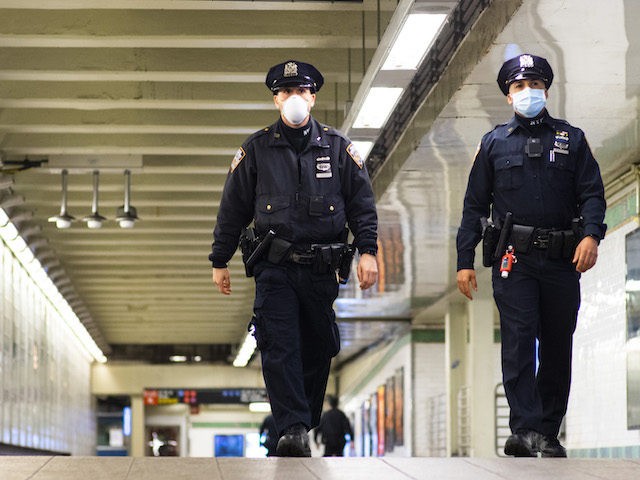 NYPD officers patrol inside Times Square station as the New York City subway system, the l