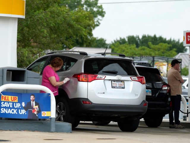 People fill up their gas tank at a gas station in Deerfield, Ill., Thursday, July 15, 2021. The national gas price average has increased 40% since the start of the year, according to AAA, and drivers can expect the price to keep rising. (AP Photo/Nam Y. Huh)