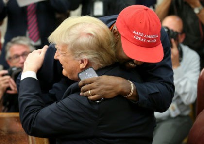 WASHINGTON, DC - OCTOBER 11: (AFP OUT) (EDITORS NOTE: Retransmission with alternate crop.) U.S. President Donald Trump hugs rapper Kanye West during a meeting in the Oval office of the White House on October 11, 2018 in Washington, DC. (Photo by Oliver Contreras - Pool/Getty Images)