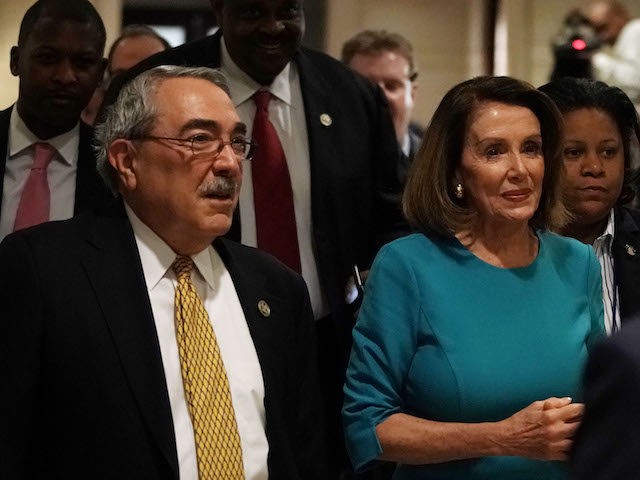 U.S. House Minority Leader Rep. Nancy Pelosi (D-CA) (C) arrives with Rep. G.K. Butterfield (D-NC) (L) at a House Democrats organizational meeting at the Capitol Visitor Center Auditorium November 28, 2018 in Washington, DC. House Democrats are holding an election today to elect leaders for the 116th Congress. (Alex Wong/Getty …
