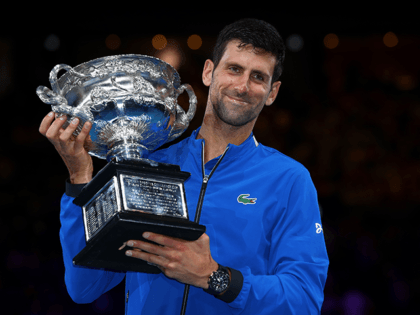 Novak Djokovic of Serbia poses with the Norman Brookes Challenge Cup following victory in