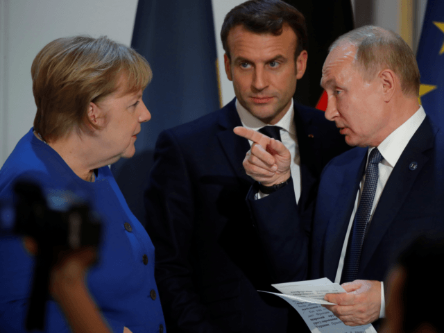 (L-R) German Chancellor Angela Merkel, French President Emmanuel Macron and Russia's President Vladimir Putin chat during a press conference after a summit on Ukraine at the Elysee Palace, in Paris, on December 9, 2019. - Leaders aim for new withdrawal of forces from Ukraine conflict zones by March 2020, according …