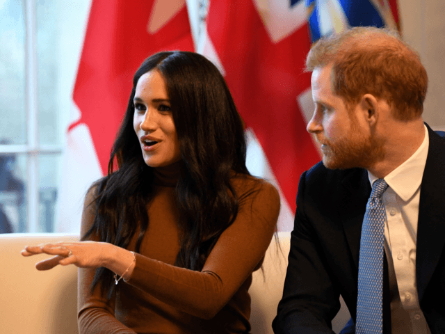 Britain's Prince Harry, Duke of Sussex (R) listens as Meghan, Duchess of Sussex speaks during their visit to Canada House in thanks for the warm Canadian hospitality and support they received during their recent stay in Canada, in London on January 7, 2020. (Photo by Daniel LEAL / POOL / …
