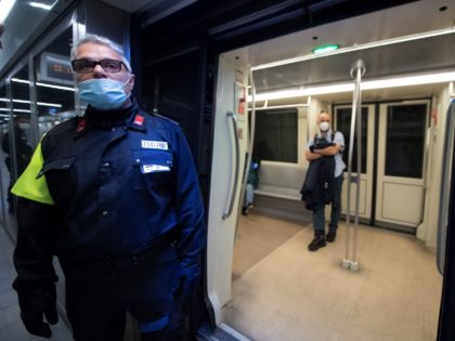 A private security agent stands by as a commuter stands in a coach during a test phase at the San Giovani underground metro station in Rome, on April 27, 2020, during the country's lockdown aimed at curbing the spread of the COVID-19 infection, caused by the novel coronavirus. - First …