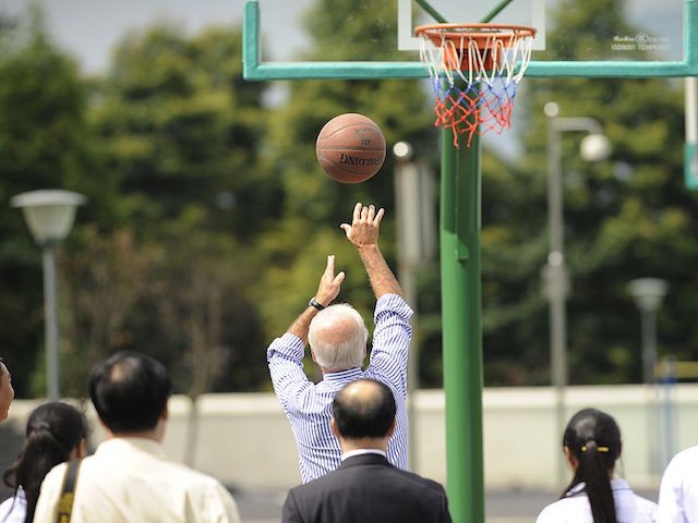 US Vice President Joe Biden (C) shoots at a basketball hoop during a visit to the Qingchengshan High School in Dujiangyan in southwestern China's Sichuan province on August 21, 2011. Biden said that the world's biggest economy has never defaulted on its debt and never would, during a visit aimed at boosting Chinese confidence in the US economy. AFP PHOTO / POOL / NG HAN GUAN (Photo credit should read NG HAN GUAN/AFP via Getty Images)