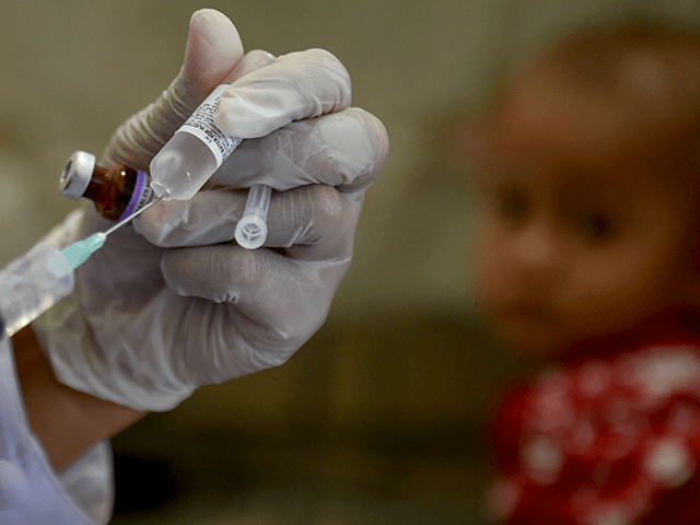 A medical worker prepares to administer the polio vaccine on a baby at a service post in Banda Aceh on November 4, 2020. (Photo by CHAIDEER MAHYUDDIN / AFP) (Photo by CHAIDEER MAHYUDDIN/AFP via Getty Images)