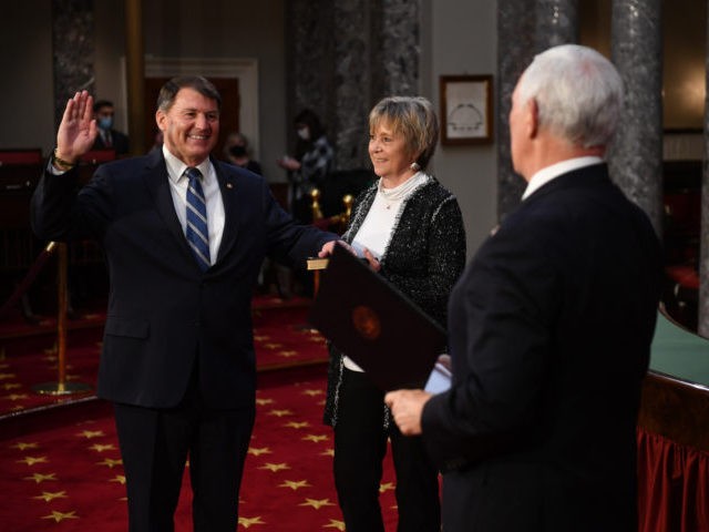 WASHINGTON, DC - JANUARY 3: Sen. Mike Rounds, (R-SD) participates in a mock swearing-in for the 117th Congress with Vice President Mike Pence, as his wife Jean Rounds holds a bible, in the Old Senate Chambers at the U.S. Capitol Building in Washington, DC. Both chambers are holding rare Sunday …