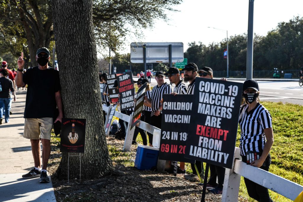 People protest against the covid-19 vaccine outside of the Raymond James Stadium prior to the Super Bowl match between Kansas City Chiefs and Tampa Bay Buccaneers in Tampa, Florida on February 7, 2021. (Photo by CHANDAN KHANNA / AFP) (Photo by CHANDAN KHANNA/AFP via Getty Images)