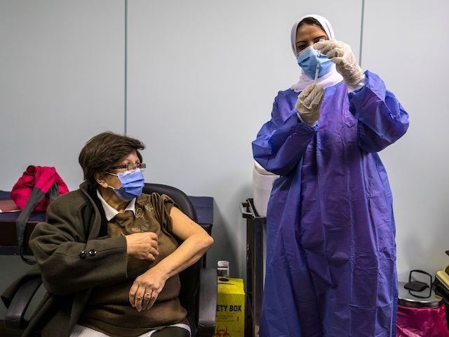 An Egyptian medical worker administers a dose of the Oxford-AstraZeneca coronavirus vaccine (Covishield) on March 4, 2021, in Cairo on the first day of vaccination in Egypt. (Khaled Desouki/AFP via Getty Images)