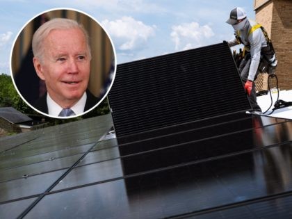 An employee with Ipsun Solar installs solar panels on the roof of the Peace Lutheran Church in Alexandria, Virginia on May 17, 2021. - Using donations, the church installed a 60.48 kilowatt solar instillation to bring down their carbon footprint. US President Joe Biden has called for the US energy …