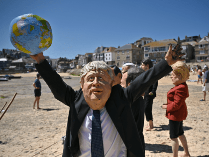 ST IVES, CORNWALL - JUNE 13: An Extinction Rebellion environmental activist wearing a Boris Johnson mask stages a demonstration during the G7 summit on June 13, 2021 in St Ives, England. Environmental Protest Groups gather in Cornwall as the UK Prime Minister, Boris Johnson, hosts leaders from the USA, Japan, …