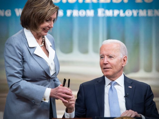 US President Joe Biden hands a pen to Speaker of the House Nancy Pelosi after signing S.J. Res. 13, a bill dealing with Employment Discrimination, during a ceremony in the Eisenhower Executive Office Building in Washington, DC, June 30, 2021. (Photo by SAUL LOEB / AFP) (Photo by SAUL LOEB/AFP …