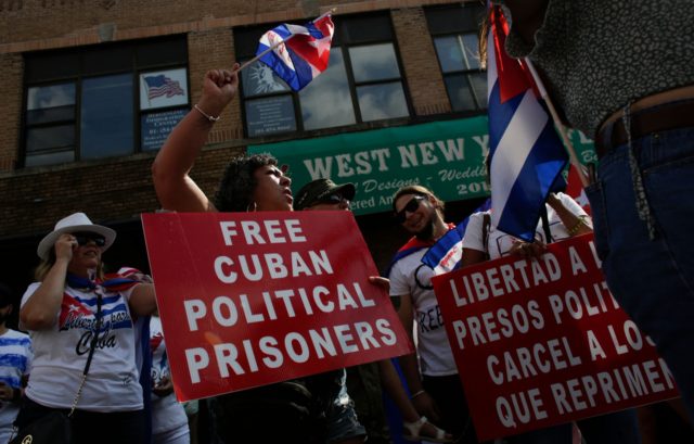 People hold signs demanding the release of Cuban political prisoners during a protest show