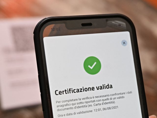 A bar owner shows a valid Green Pass on the VerifyC19 mobile phone application in central Rome on August 6, 2021, as Italy made the Green Pass, which is an extension of the EU's digital Covid certificate, required from today to enter cinemas, museums and indoor sports venues, or eat …