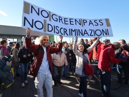 This photo obtained from Italian news agency Ansa shows dockers and port workers gathering for a protest in the port of Trieste, Friuli Venezia Giulia, on October 15, 2021 as new coronavirus restrictions for workers come into effect. - Italy braced for nationwide protests, blockades and potential disruption on October …