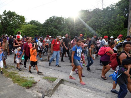 TOPSHOT - Migrants marching in caravan to Mexico City to request asylum and refugee status on their way to the United States, walk in Escuintla, Chiapas State, Mexico, on October 26, 2021. - Around 1,000 migrants seeking refugee status are marching towards the Mexican capital, as the government faced a …