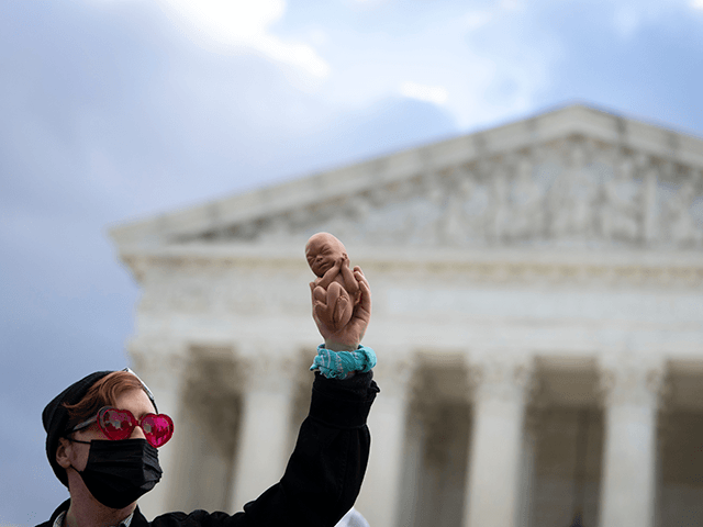 An anti-abortion demonstrator protests outside the U.S. Supreme Court on November 01, 2021 in Washington, DC. On Monday, the Supreme Court is hearing arguments in a challenge to the controversial Texas abortion law which bans abortions after 6 weeks. (Photo by Drew Angerer/Getty Images)