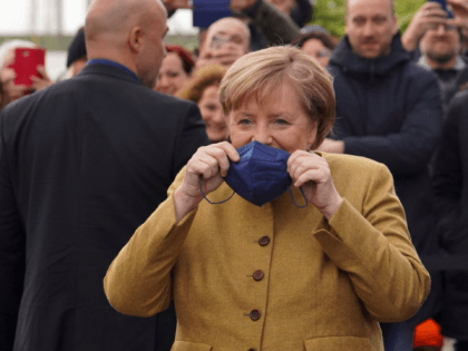 Outgoing German Chancellor Angela Merkel (C) arrives at the "Deutsches Auswandererhaus" Ge