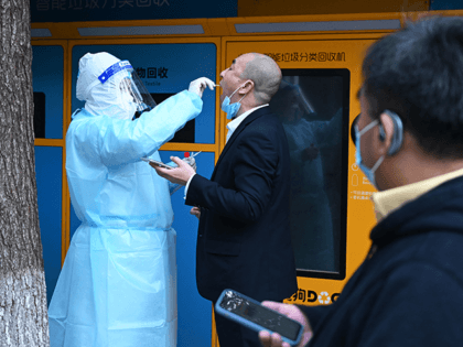 A medical worker takes a swab sample to be tested for the Covid-19 coronavirus in Beijing