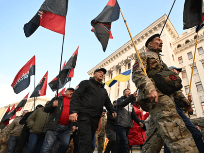 Participants of the war with Russia backed separatists on the east of Ukraine, activists of Right Sector, far-right movement hold flags as they march after their rally called "Stop the creeping occupation!" outside the office of Ukrainian President Volodymyr Zelensky in Kiev on November 4, 2021. - Protesters warned the …
