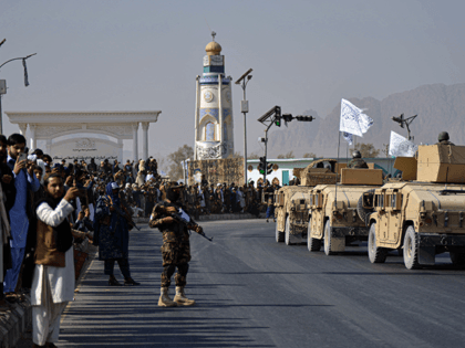 People watch a Taliban military parade of the Al-Badr unit in Kandahar on November 8, 2021. (Photo by Javed TANVEER / AFP) (Photo by JAVED TANVEER/AFP via Getty Images)