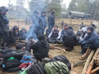 A picture taken on November 10, 2021 shows migrants at a camp on the Belarusian-Polish border in the Grodno region. - Hundreds of desperate migrants are trapped in freezing temperatures on the border and the presence of troops from both sides has raised fears of a confrontation. - Belarus OUT …