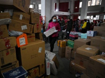 A worker prepares a package for delivery at a JD.com distribution centre on "Singles Day", also known as the Double 11, the biggest shopping day of the year, in Beijing on November 11, 2021. (Photo by GREG BAKER / AFP) (Photo by GREG BAKER/AFP via Getty Images)
