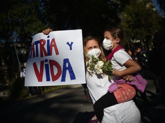 A group of Cubans living in Mexico demonstrate in support of the Cuban opposition, in fron