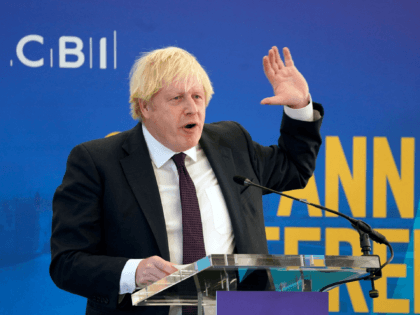 Britain's Prime Minister Boris Johnson speaks at the Confederation of Business Industry (CBI) annual conference, at the Port of Tyne, in South Shields, north east England on November 22, 2021. - Britain will make electric car chargers compulsory for new buildings in England from 2022, as it switches away from …