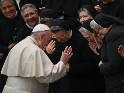 Pope Francis prays with a group of nuns during the weekly general audience on November 24,