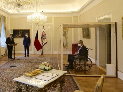 Covid-struck Czech President Milos Zeman, sits in a plastic cage as he appoints ODS leader Petr Fiala (L) as Czech Prime Minister at the Lany manor, near Prague, on November 28, 2021. - Petr Fiala was named the Czech Republic's new prime minister on Sunday in an unusual ceremony, with …