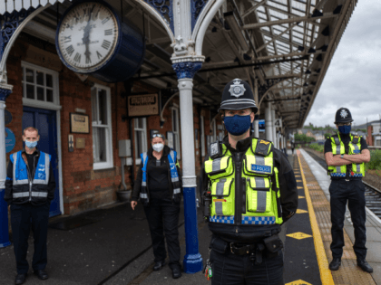 STALYBRIDGE, ENGLAND - JULY 04: Police Officers and security guards patrol outside Stalybridge Buffet Bar, situated on the platform at Stalybridge Train Station, which usually receives a large amount of custom from rail passengers heading into Manchester on July 04, 2020 in Stalybridge, England. The UK Government announced that Pubs, …
