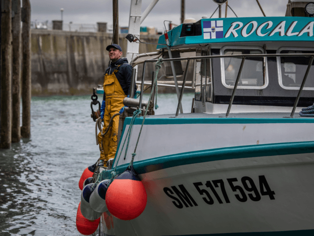 GRANVILLE, FRANCE - MAY 6: French fishermen approach a dock to unload the day's catch from their boat on May 6, 2021 to store in the fishery harbour of Granville, France. French fishery representatives call on the urgency of the situation concerning the restrictions put in place in Jersey waters …