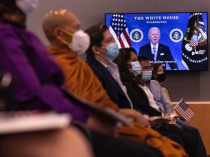 CAMP SPRINGS, MARYLAND - MAY 27: New U.S. citizens listen to remarks from a recorded message by President Joe Biden during their Naturalization Ceremony at the United States Citizenship and Immigration Services (USCIS) Headquarters on May 27, 2021 in Camp Springs, Maryland. This special Naturalization Ceremony honored Asian American Pacific …