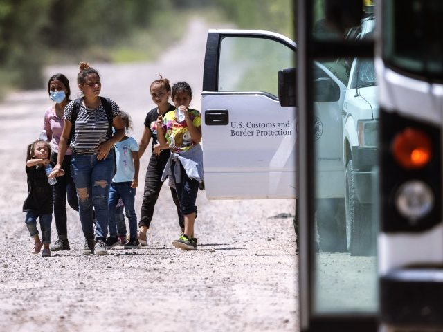 LA JOYA, TEXAS - AUGUST 13: Immigrant families walk to a U.S. Border Patrol checkpoint for transport to a processing center after they crossed the U.S.-Mexico border on August 13, 2021 in La Joya, Texas. U.S. Customs and Border Protection figures show more than 200,000 people were apprehended crossing the …