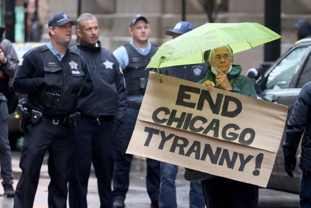 CHICAGO, ILLINOIS - OCTOBER 25: Chicago police officers along with other city workers and their supporters protest at city hall the mayor's vaccination policy for city employees on October 25, 2021 in Chicago, Illinois. The city has started to place police officers on unpaid leave for refusing to comply with the city's requirements that they report their COVID-19 vaccination status. As of last week, only about 65 percent of the city's police have complied with the order. (Photo by Scott Olson/Getty Images)