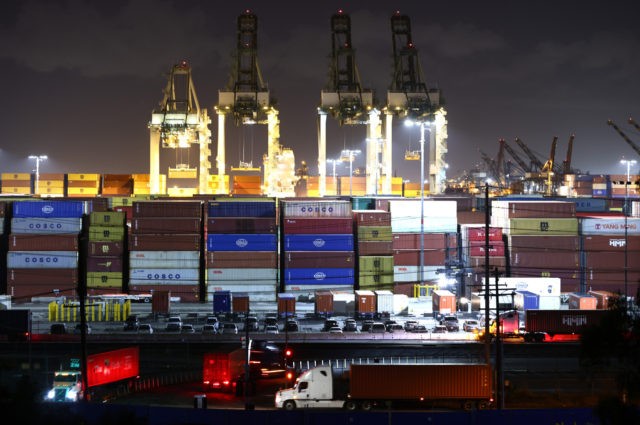 SAN PEDRO, CALIFORNIA - OCTOBER 25: Trucks haul shipping containers at the Port of Los Angeles during nighttime operations on October 25, 2021 in San Pedro, California. The Port of Los Angeles is joining the Port of Long Beach in 24/7 operations amid efforts to ease supply chain issues. Strong …