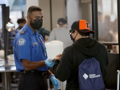 CHICAGO, ILLINOIS - NOVEMBER 08: Transportation Security Administration (TSA) workers screen passengers at O'Hare International Airport on November 08, 2021 in Chicago, Illinois. Monday is the deadline for federal workers to report whether they have been vaccinated against the COVID-19 coronavirus. Recent data indicate that only about 60 percent of …
